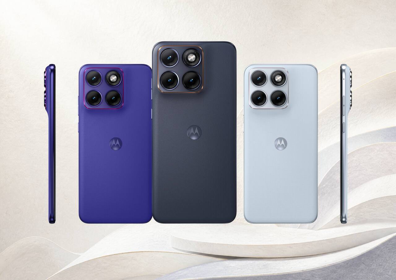 motorola-edge-70-fusion-three-colors - innovaTopia Multiple smartphones shown from the back in purple, dark blue, navy, and light gray, with prominent triple-camera modules lined along the top corner.